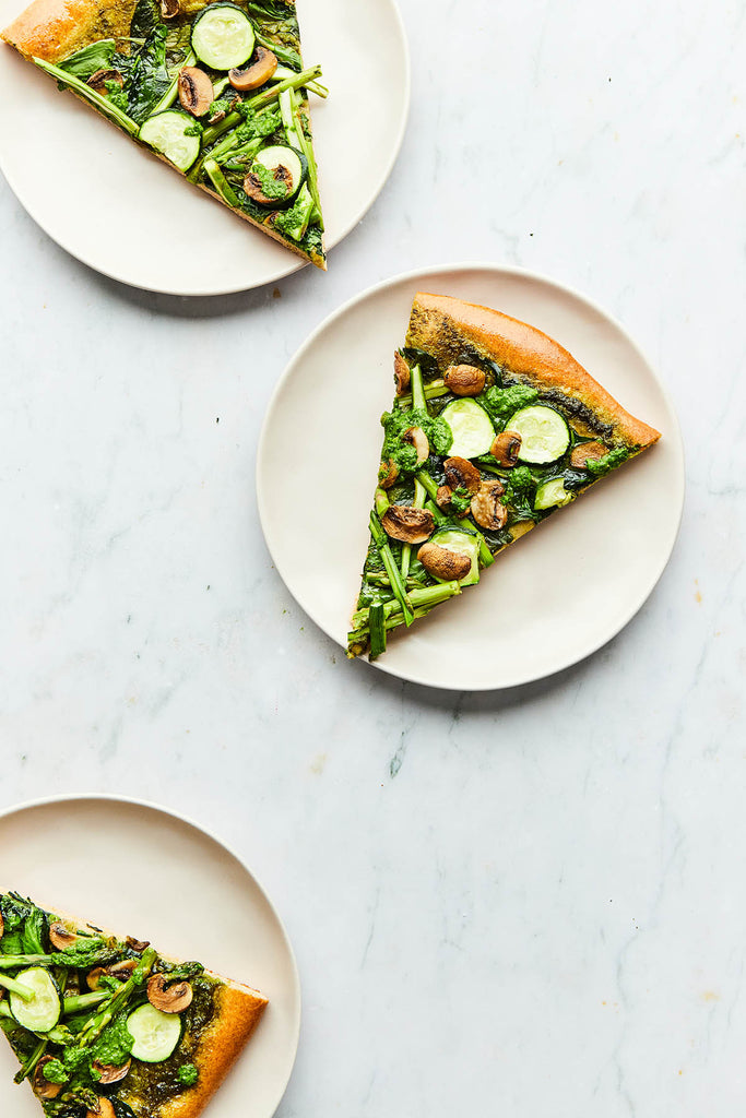 This fresh, bright spring pesto pizza recipe comes from Alexandra Daum’s beautiful debut cookbook Occasionally Egg
