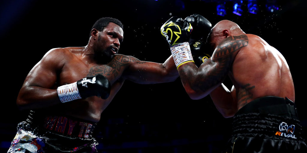 Dillian Whyte overcomes a knockdown to win a back-and-forth blockbuster, setting up a potential Deontay Wilder payday next year